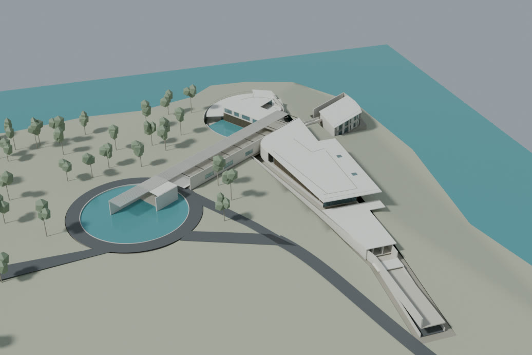 A white architectural model of a long, low residence on a headland by the water, with trees, two circular pools and a curved road, rebuilt from drawings made in 2011.